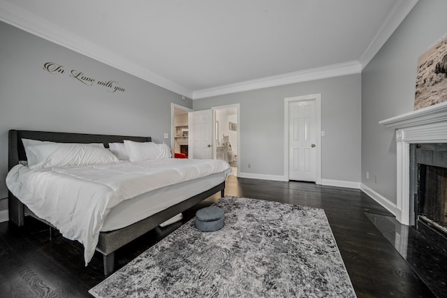 bedroom featuring connected bathroom, dark wood-type flooring, and ornamental molding