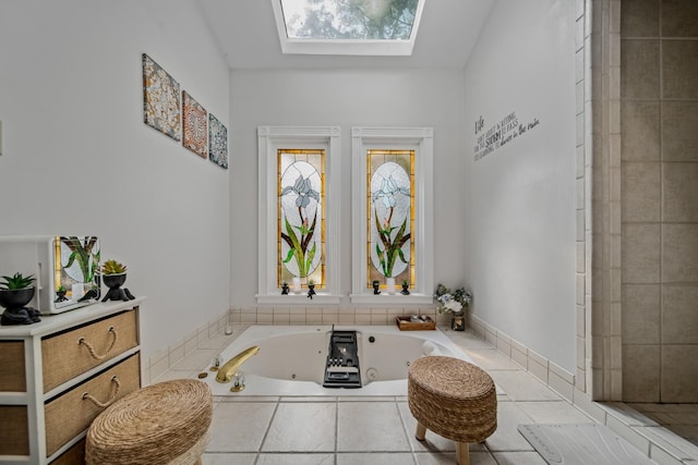 bathroom featuring tiled bath and vaulted ceiling with skylight