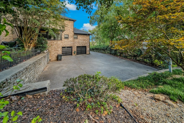 view of side of property featuring a garage and central air condition unit