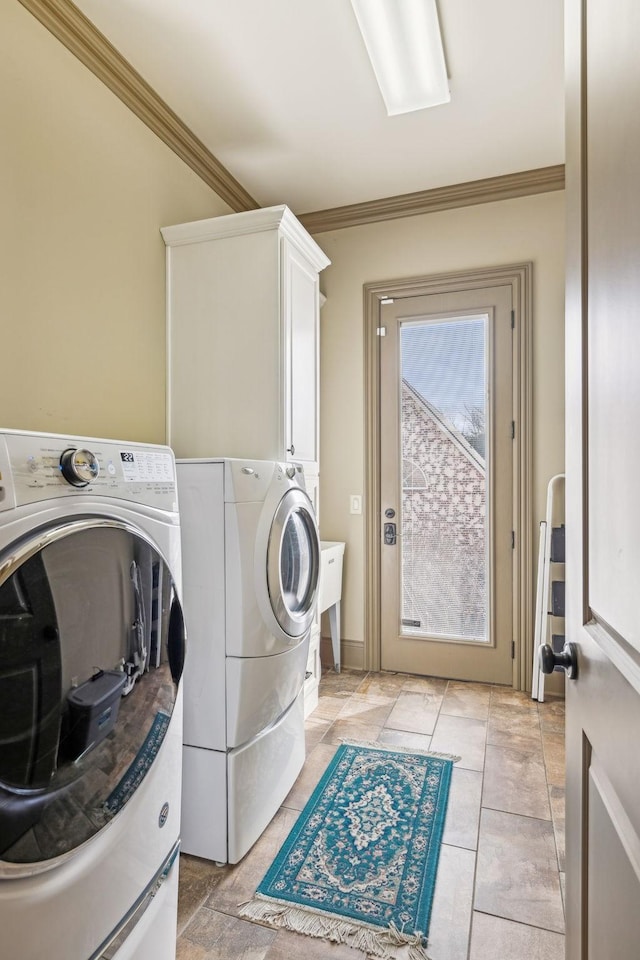 laundry room with washer and dryer, crown molding, cabinets, and light tile patterned flooring