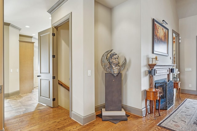 corridor featuring light hardwood / wood-style floors and ornamental molding