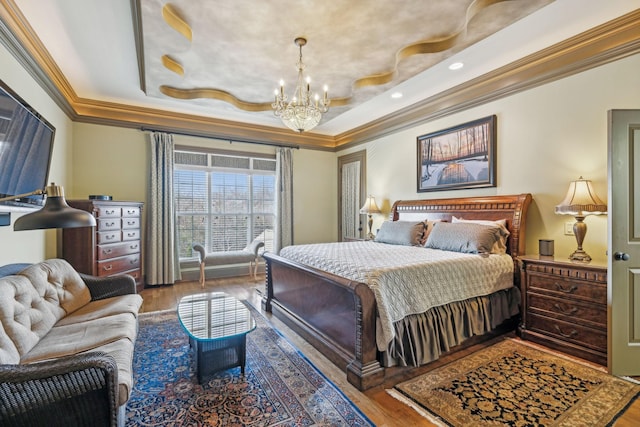 bedroom featuring a raised ceiling, wood-type flooring, crown molding, and a chandelier