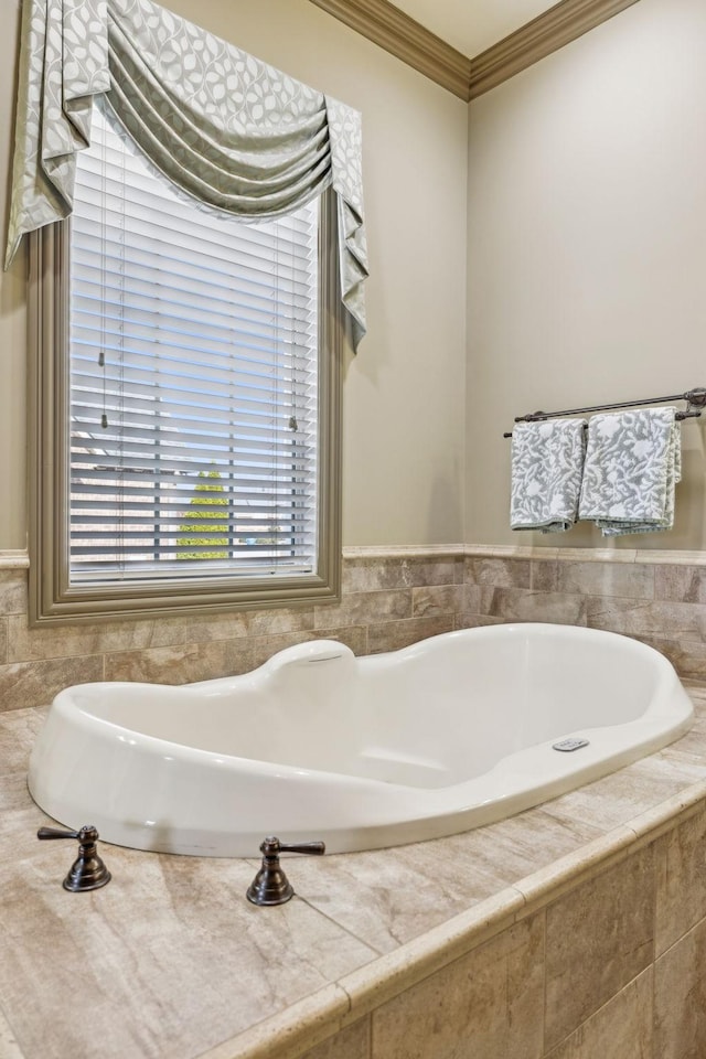 bathroom featuring tiled bath and ornamental molding