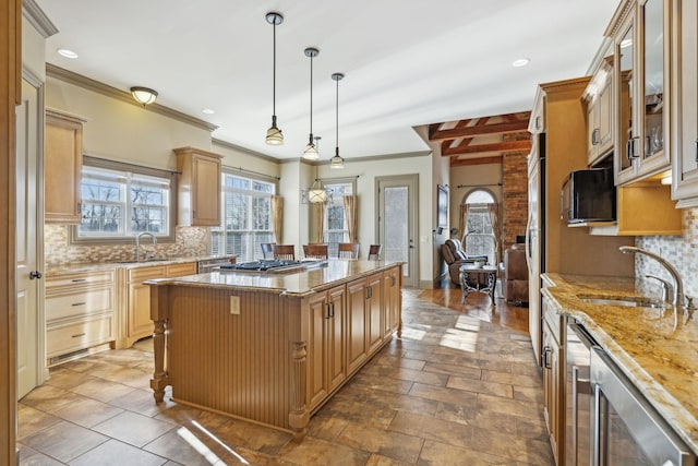 kitchen featuring backsplash, sink, beam ceiling, a kitchen island, and hanging light fixtures