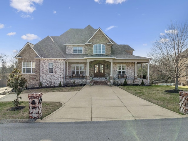 craftsman-style home featuring a porch and a front yard