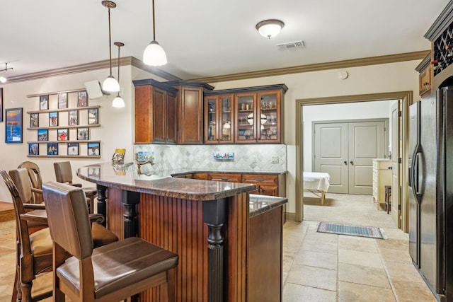 bar with backsplash, stainless steel fridge, pendant lighting, and ornamental molding