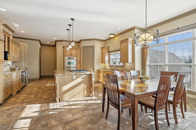 dining area with plenty of natural light, crown molding, and an inviting chandelier