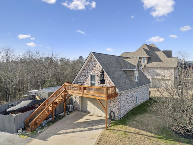 view of front of property with central AC, a garage, and a deck