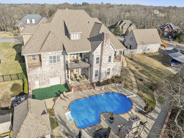 view of pool featuring a diving board and a patio