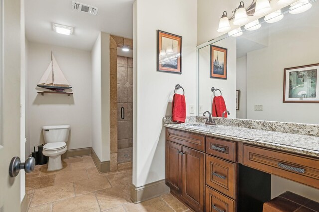 bathroom with vanity, toilet, and walk in shower