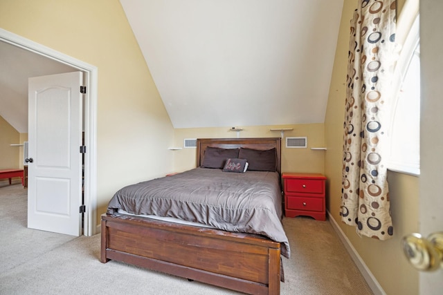 bedroom with light colored carpet and lofted ceiling