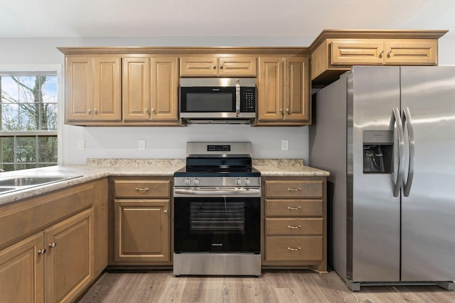 kitchen featuring light hardwood / wood-style flooring, stainless steel appliances, and sink