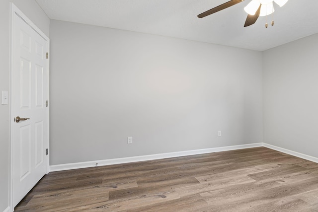 unfurnished room with hardwood / wood-style floors and ceiling fan