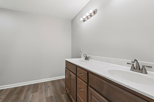 bathroom featuring a textured ceiling, vanity, and hardwood / wood-style flooring