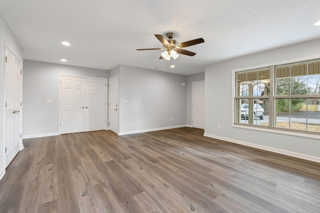 empty room featuring wood-type flooring and ceiling fan