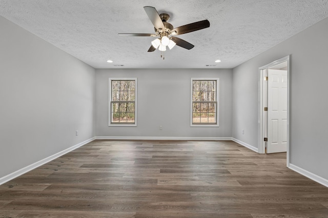 unfurnished room featuring a textured ceiling, ceiling fan, and dark wood-type flooring