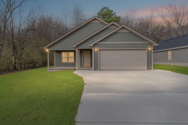 view of front of home featuring a yard, covered porch, and a garage