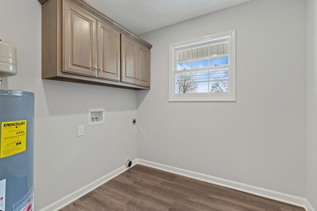 washroom featuring cabinets, hookup for a washing machine, hookup for an electric dryer, electric water heater, and dark hardwood / wood-style floors