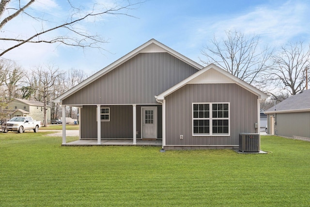 rear view of property with a yard, a patio area, and central air condition unit