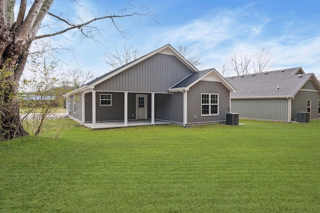 back of house with a patio area, a yard, and central AC