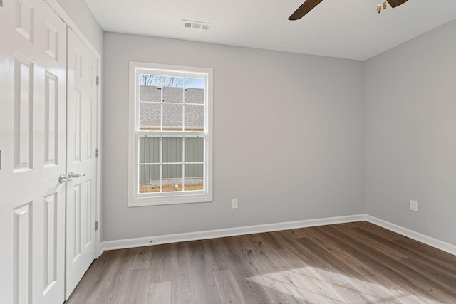 empty room featuring hardwood / wood-style flooring and ceiling fan