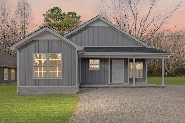 view of front of property with a lawn and covered porch