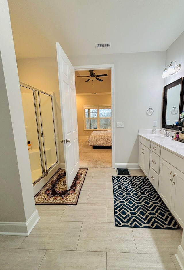 bathroom with vanity, ceiling fan, and an enclosed shower