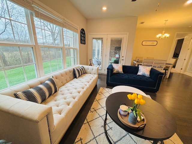 living room with an inviting chandelier and light hardwood / wood-style floors