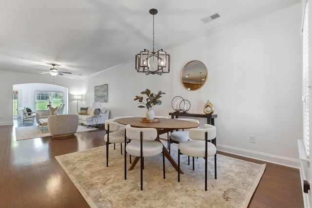 dining area with hardwood / wood-style floors, ceiling fan with notable chandelier, and ornamental molding