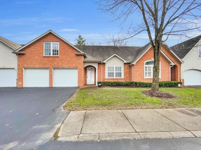 view of front of house with a garage and a front lawn