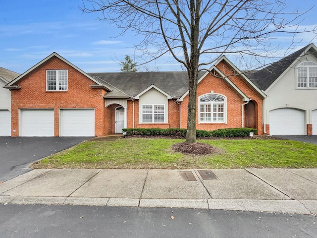 view of front of property featuring a garage and a front lawn