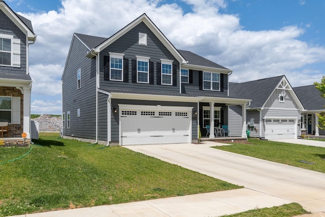 view of front of property featuring a porch, a garage, and a front yard