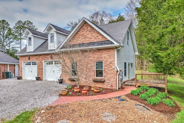 view of front of house with central air condition unit, a wooden deck, and a garage