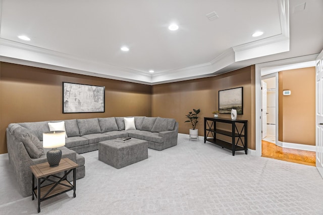 living room featuring carpet floors, a tray ceiling, and ornamental molding