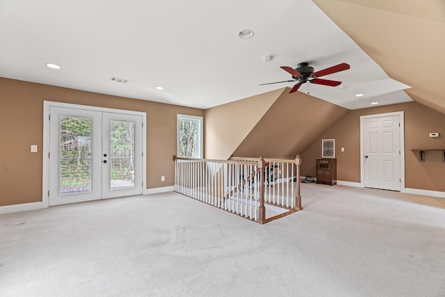 bonus room featuring ceiling fan, french doors, light colored carpet, and lofted ceiling