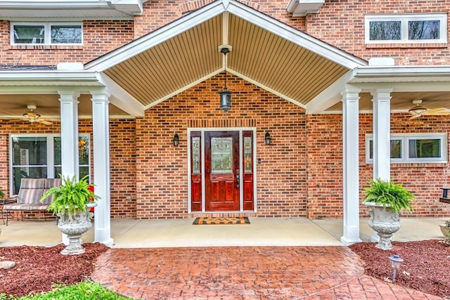 property entrance with ceiling fan and a porch