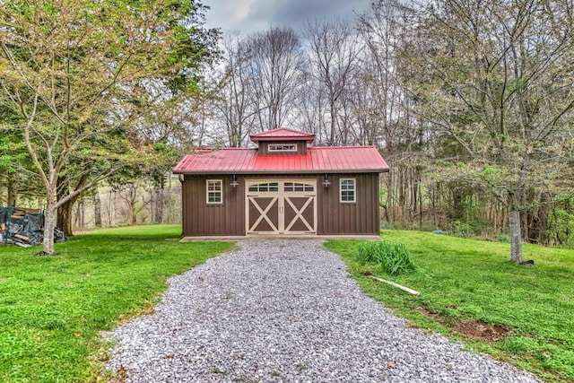 view of outbuilding featuring a yard