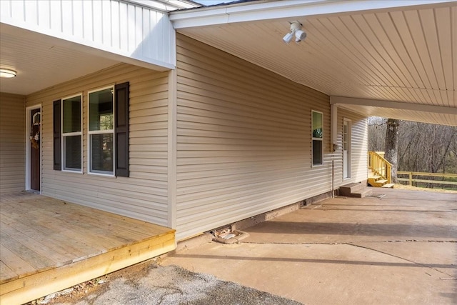 view of side of property featuring a carport and driveway