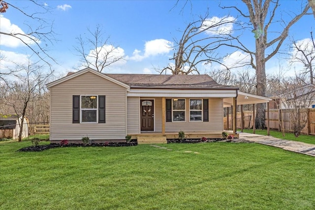 view of front of house featuring covered porch, an attached carport, a front lawn, and fence