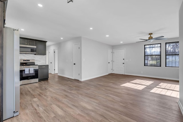 unfurnished living room with ceiling fan and light hardwood / wood-style flooring