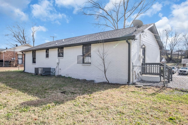 back of house featuring a yard and cooling unit