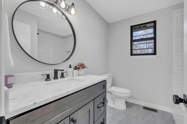 bathroom featuring vanity and toilet