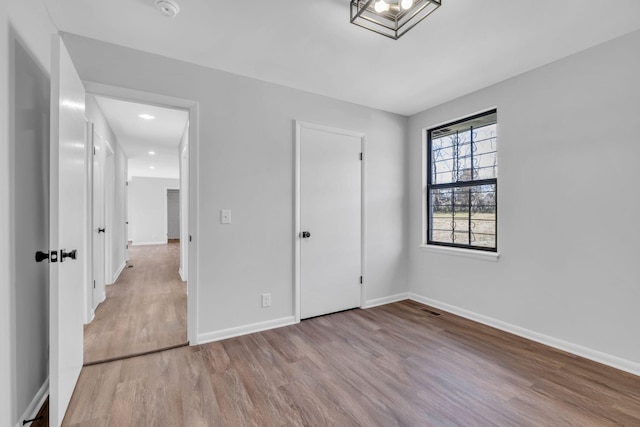 unfurnished bedroom featuring light hardwood / wood-style floors and a closet