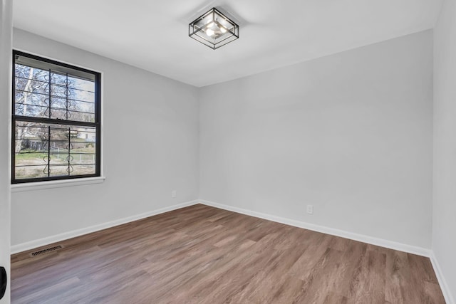 unfurnished room with hardwood / wood-style floors