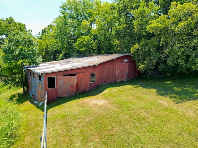 view of outbuilding featuring a yard