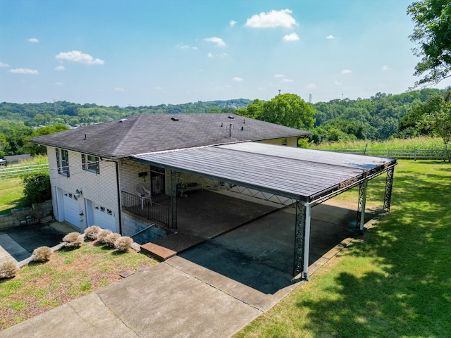 exterior space featuring a garage and a lawn