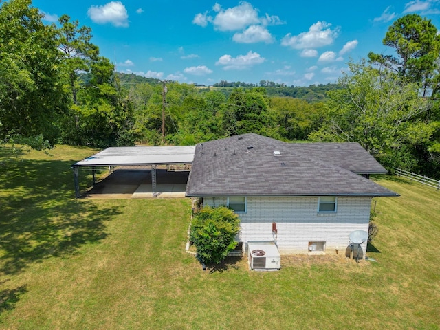 back of property featuring a lawn