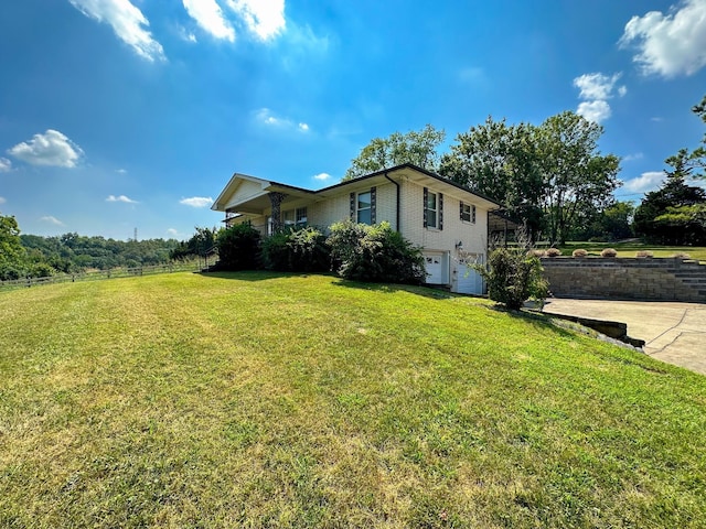 view of property exterior featuring a garage and a yard