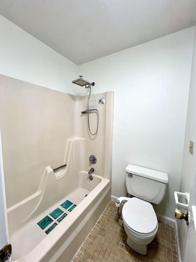 bathroom with tile patterned flooring, bathtub / shower combination, and toilet