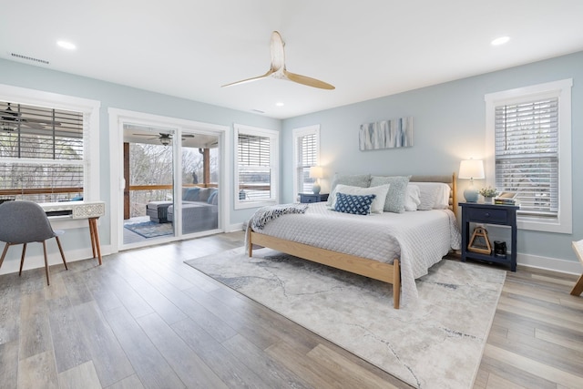 bedroom with access to outside, light hardwood / wood-style flooring, and ceiling fan